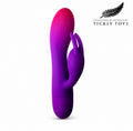 A purple and pink gradient silicone personal massager with a finger-like sleeve, shown on a white background with the Tickly Toys brand logo in the top right corner.
