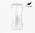 Clear Ripple dual-end stroker with textured ribbed interior beside its on a white background.